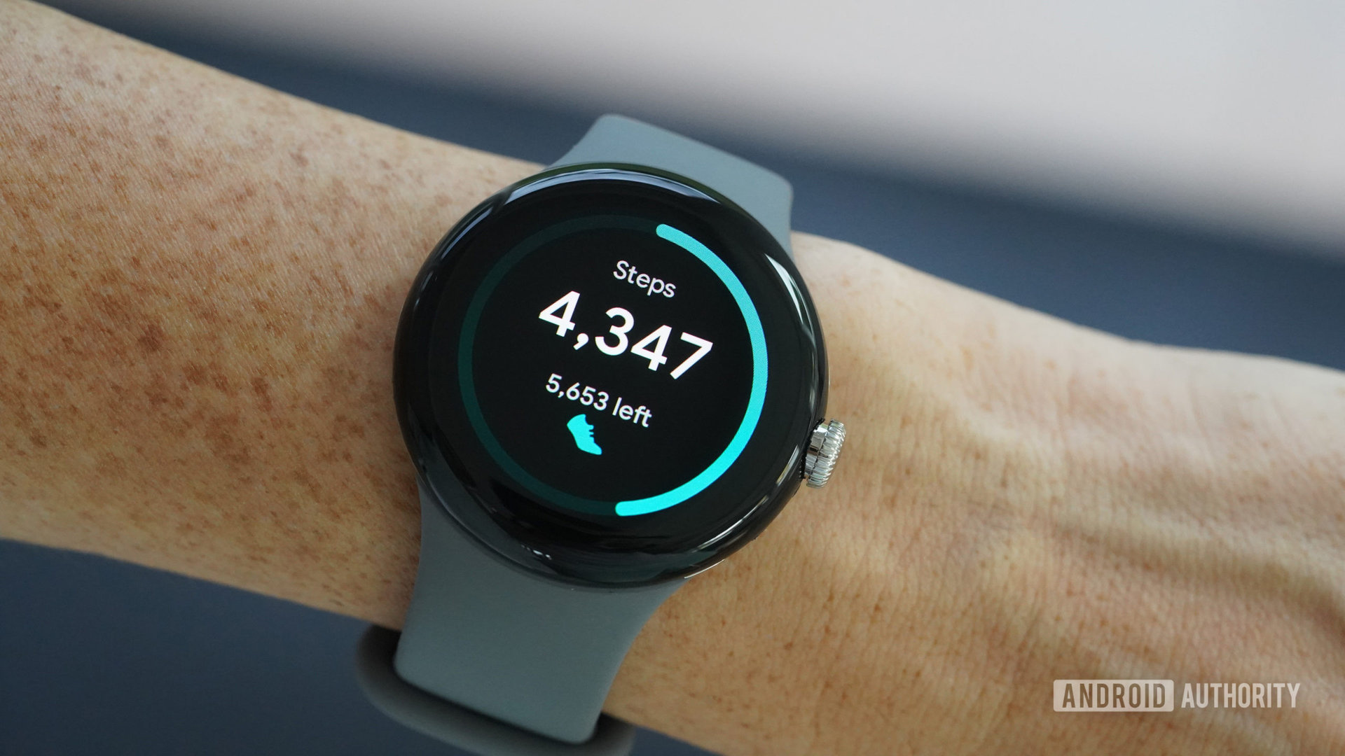 A Google Pixel Watch displays a user's step count.