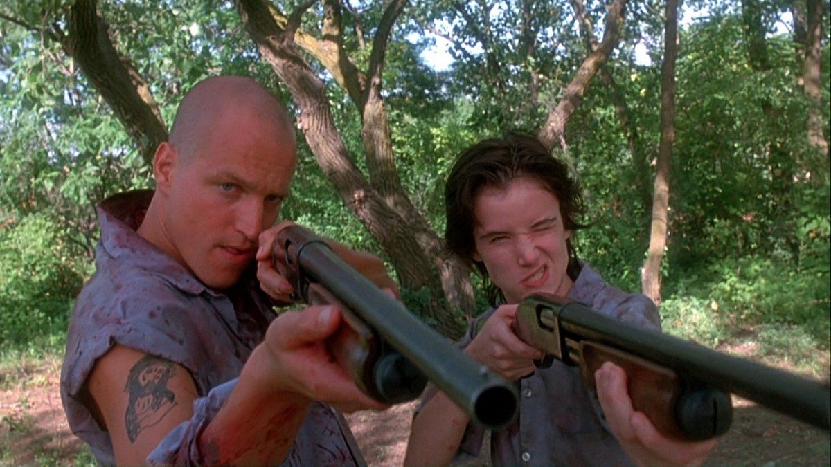 A man and woman aim shotguns in Natural Born Killers - best crime thrillers on Netflix