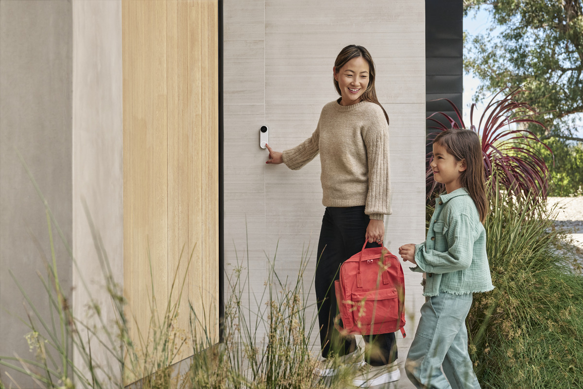 Woman touching doorbell next to child