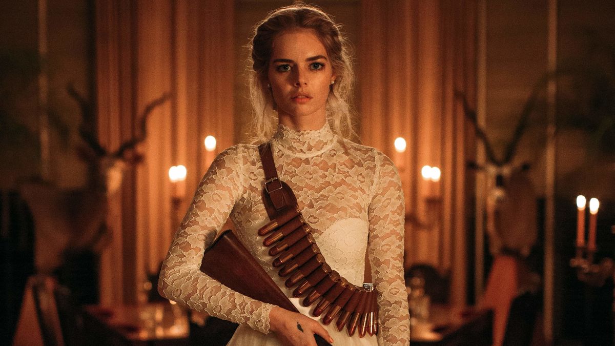 Samara Weaving in a wedding gown, carrying a rifle in Ready or Not - movies like glass onion