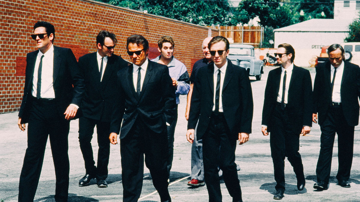 Men in black suits walk down the street in Reservoir Dogs - best netflix thrillers