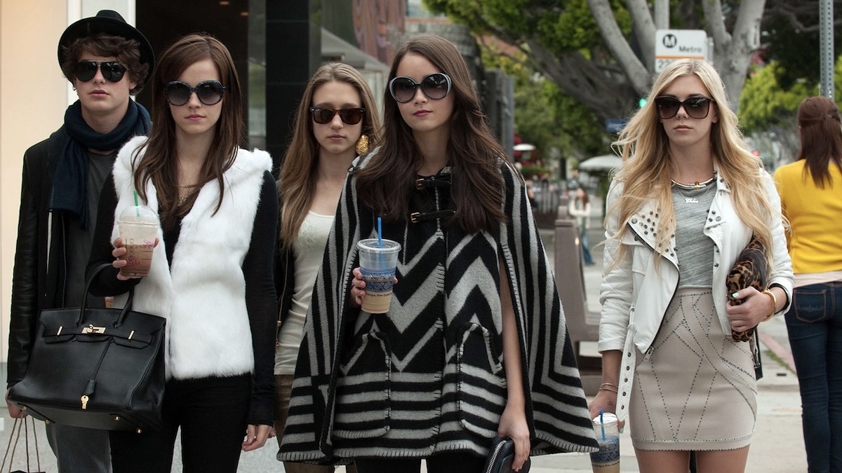 Teens in trendy 2000s clothes walk down the street in Hollywood in The Bling Ring