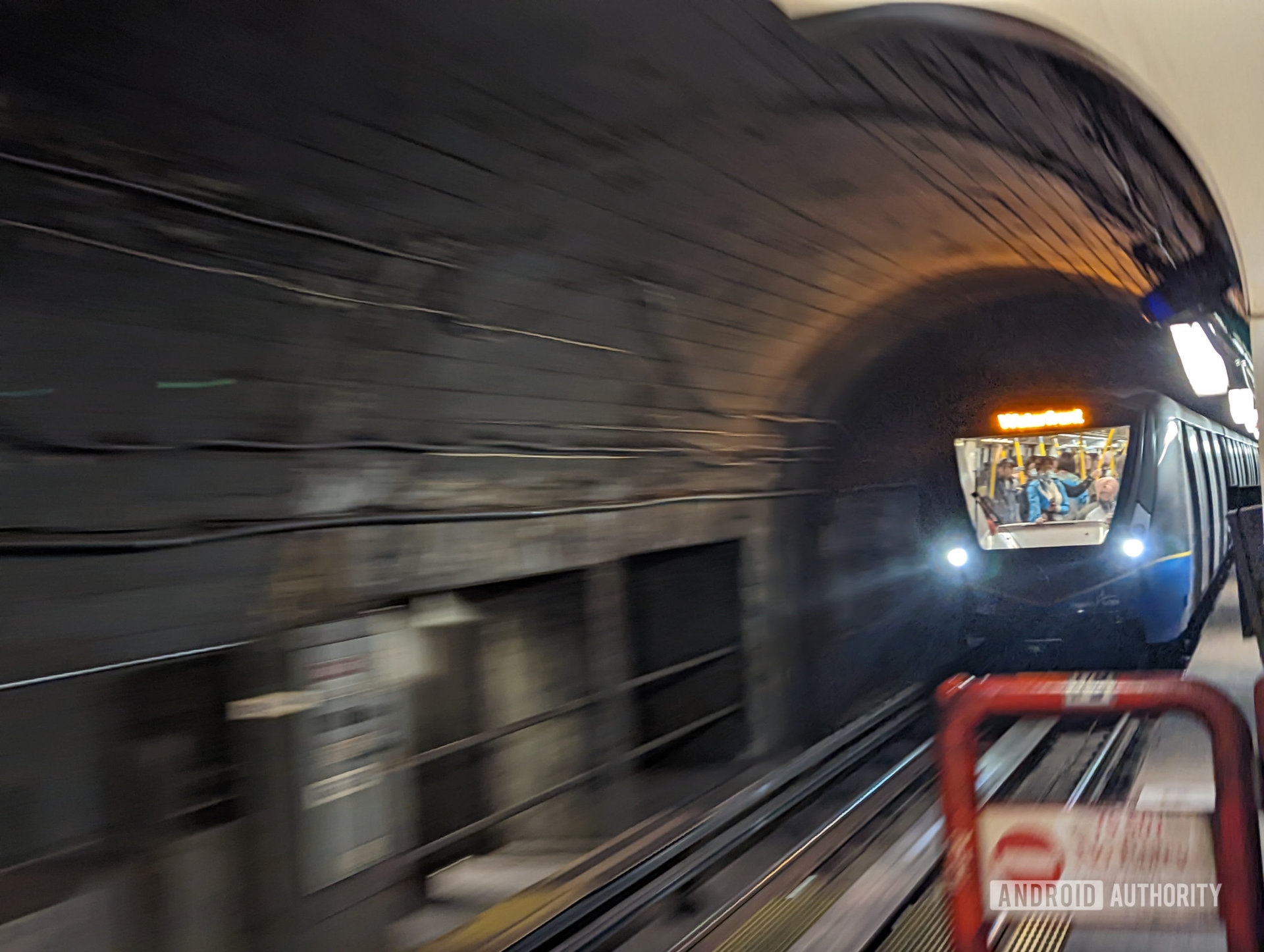 A photo taken of a subway train using a Google Pixel 6's Action Pan feature. The subway car is clear and sharp while the tunell has a motion blur-like effect added.