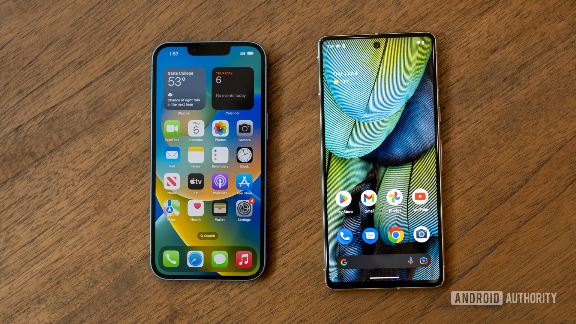 A Google Pixel 7 next to an Apple iPhone 14 in a wood table showing the two phones' lock screens.