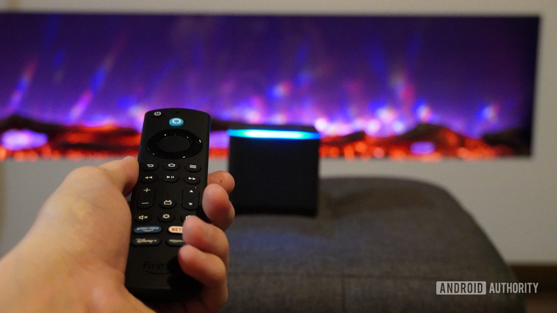 Fire TV Cube with remote in hand
