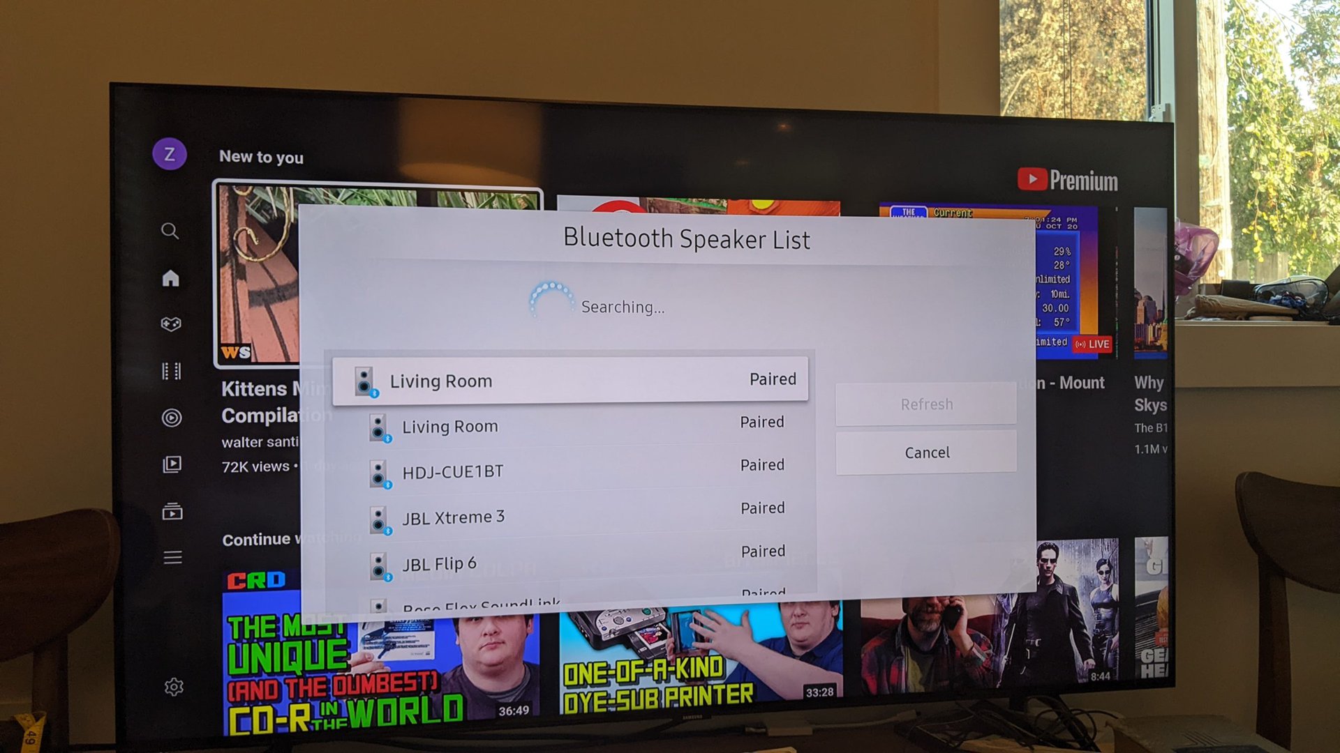 A photograph of a Samsung TV showing the Bluetooth speaker list.