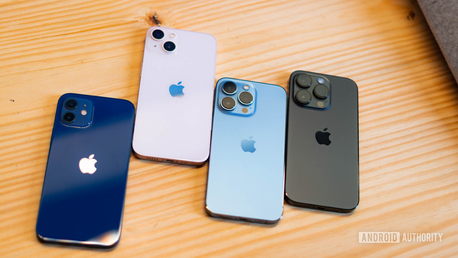 Empat iPhone berbaring telungkup menunjukkan tampilan belakang