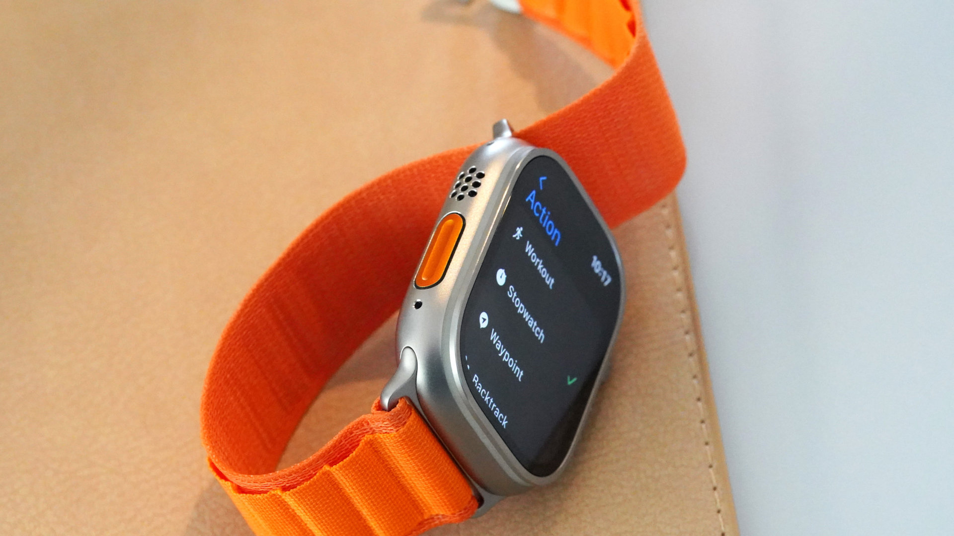 An Apple Watch Ultra rests on its side, displaying the Action button settings menu.