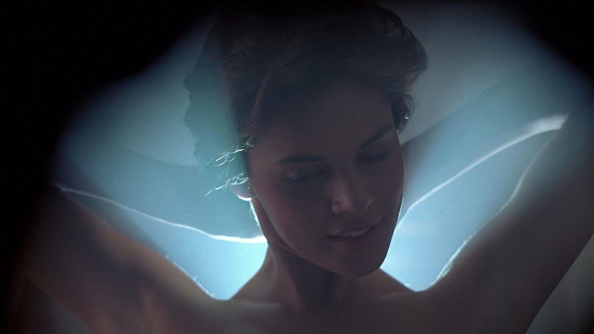 A woman bathed in blue light in Cocoon - disney plus revivals