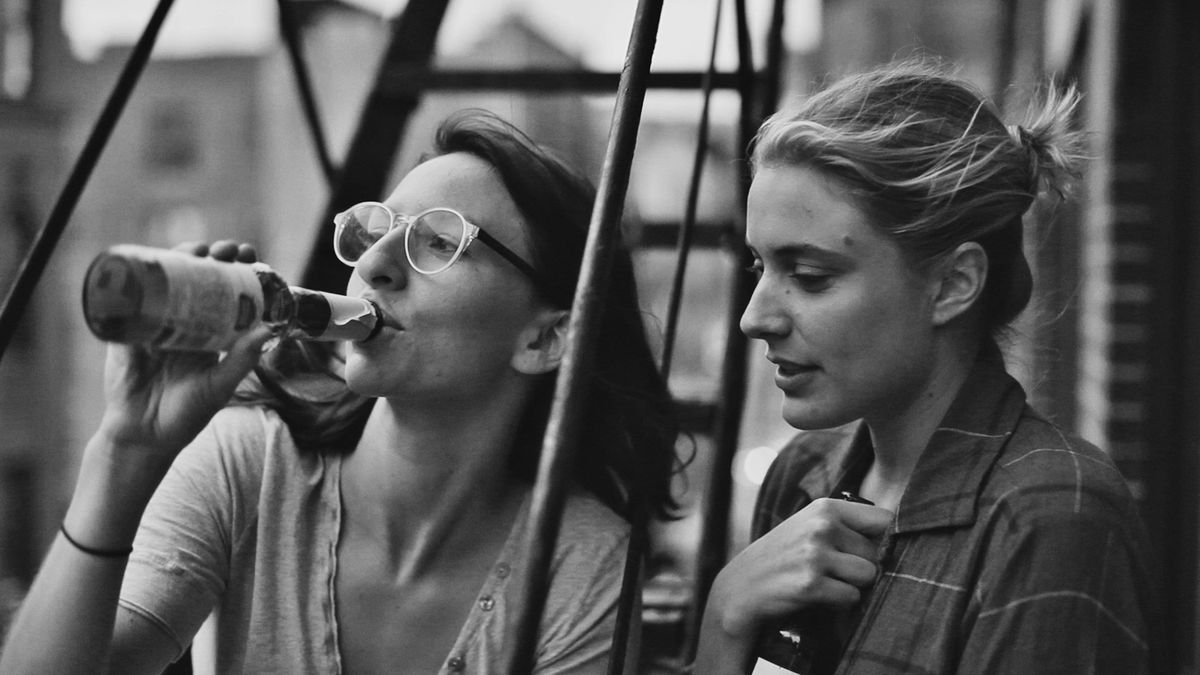 Two women drink on a fire escape in black and white in Frances Ha - best netflix comedies