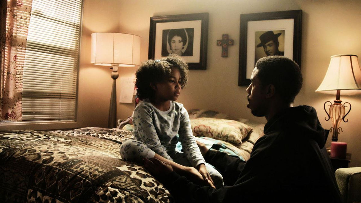 Michael B Jordan sits with a child in Fruitvale Station - best new streaming movies