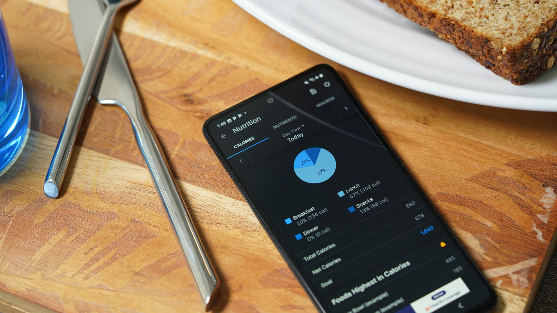 A Galaxy A51 displays a user's nutritional intake in the MyFitnessPal app.