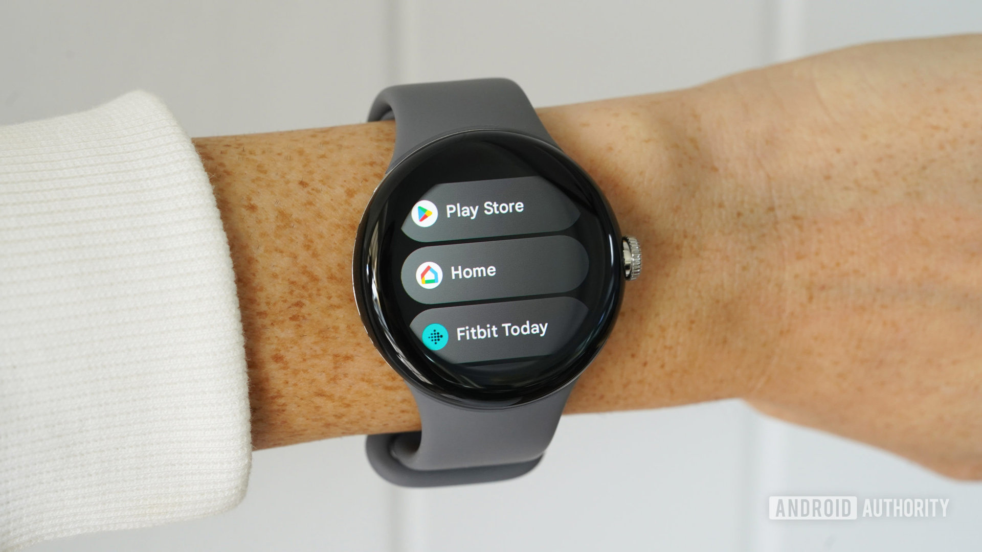 A Google Pixel Watch on a users' wrist displays their Recent Apps list.