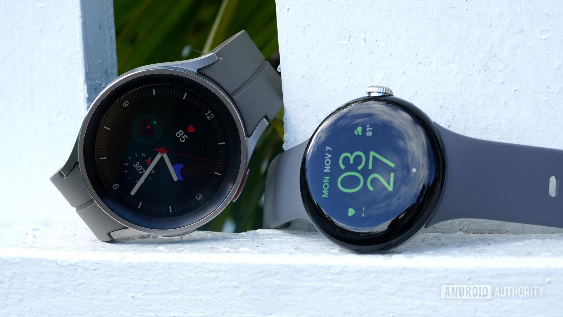 A Google Pixel Watch sits next to a Galaxy Watch 5 pro.