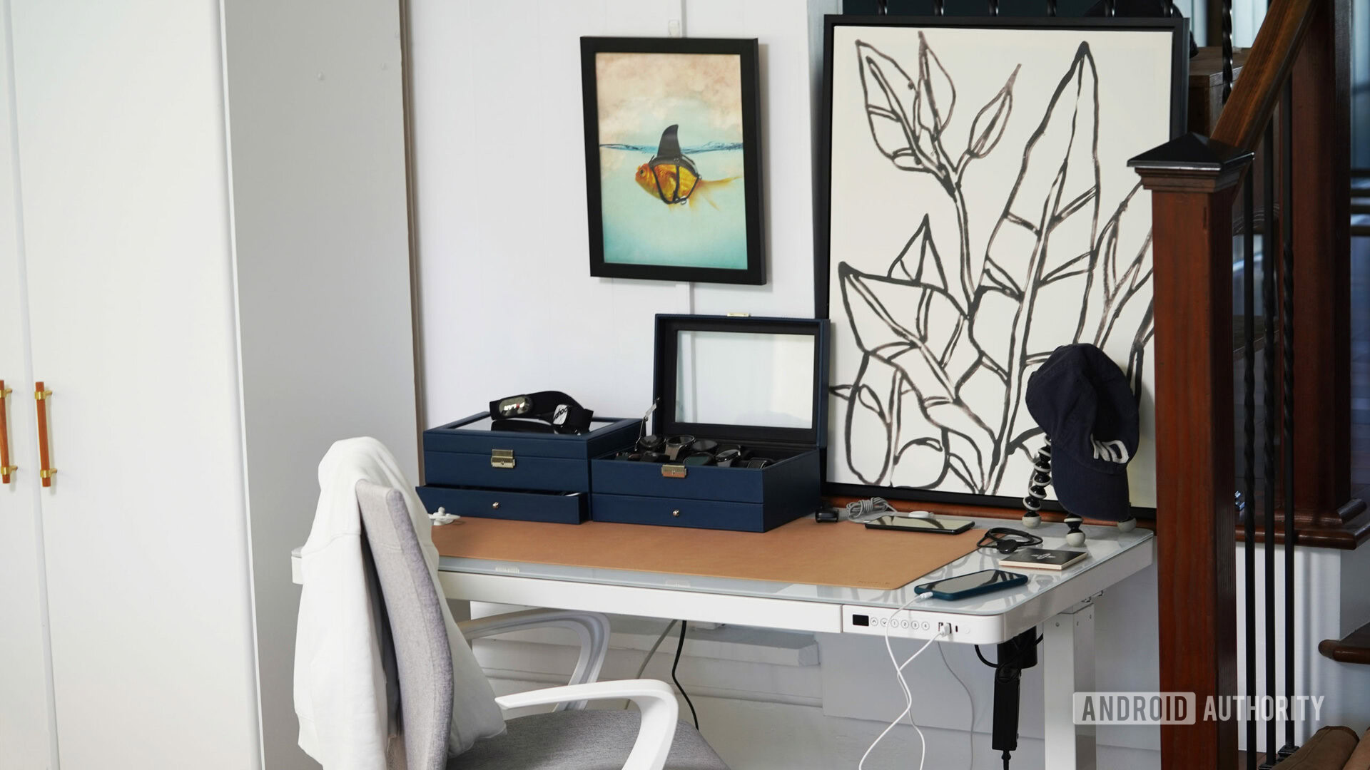 Two watch cases, two telephones, and a bundle of cables rested on the examiner's desk.