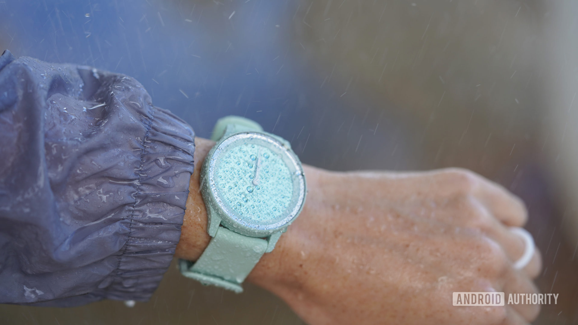 A reviewers tests a Garmin Vivomove Sport in the pouring rain.