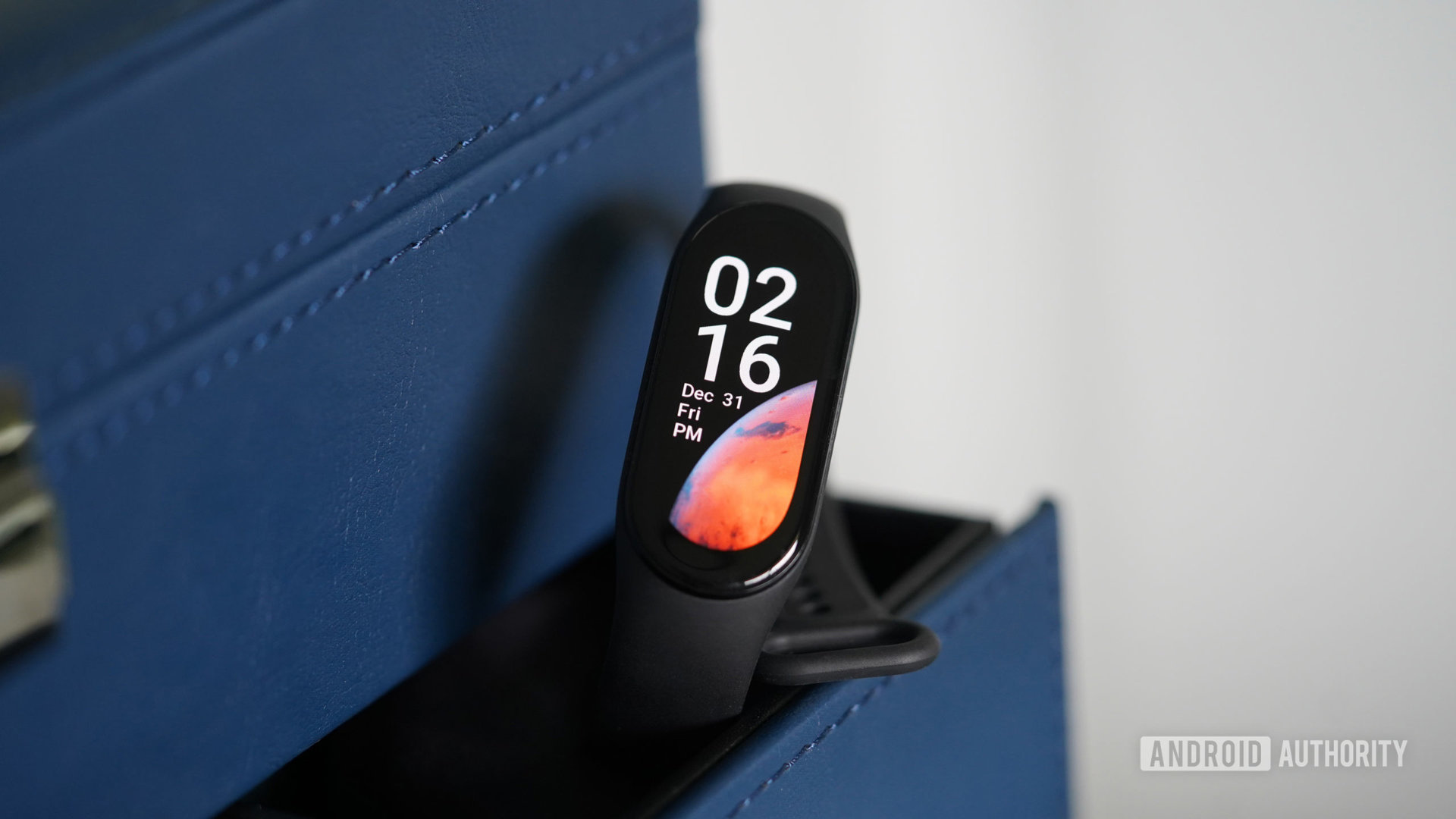 A Xiaomi Mi Band 8 rests in the drawer of a watch box.