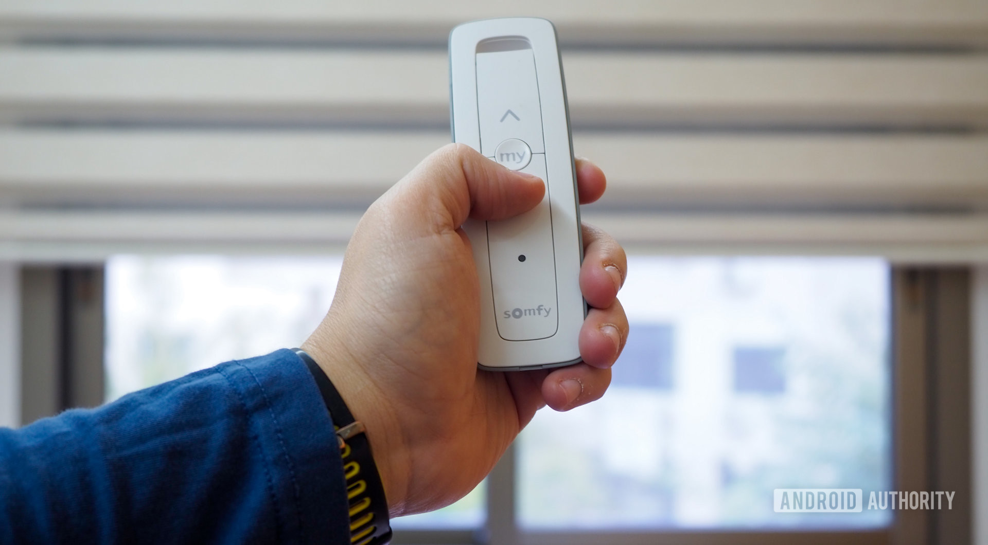somfy smart blinds manual remote in hand
