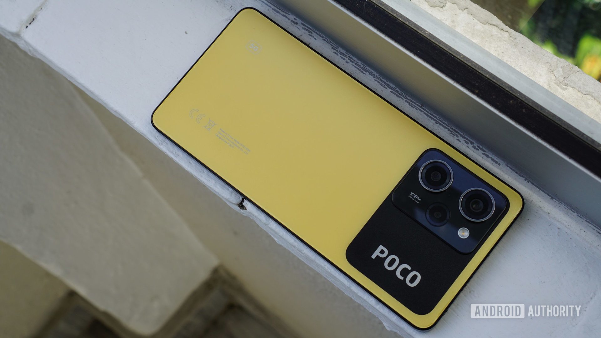 Poco X5 Pro face down on window ledge 