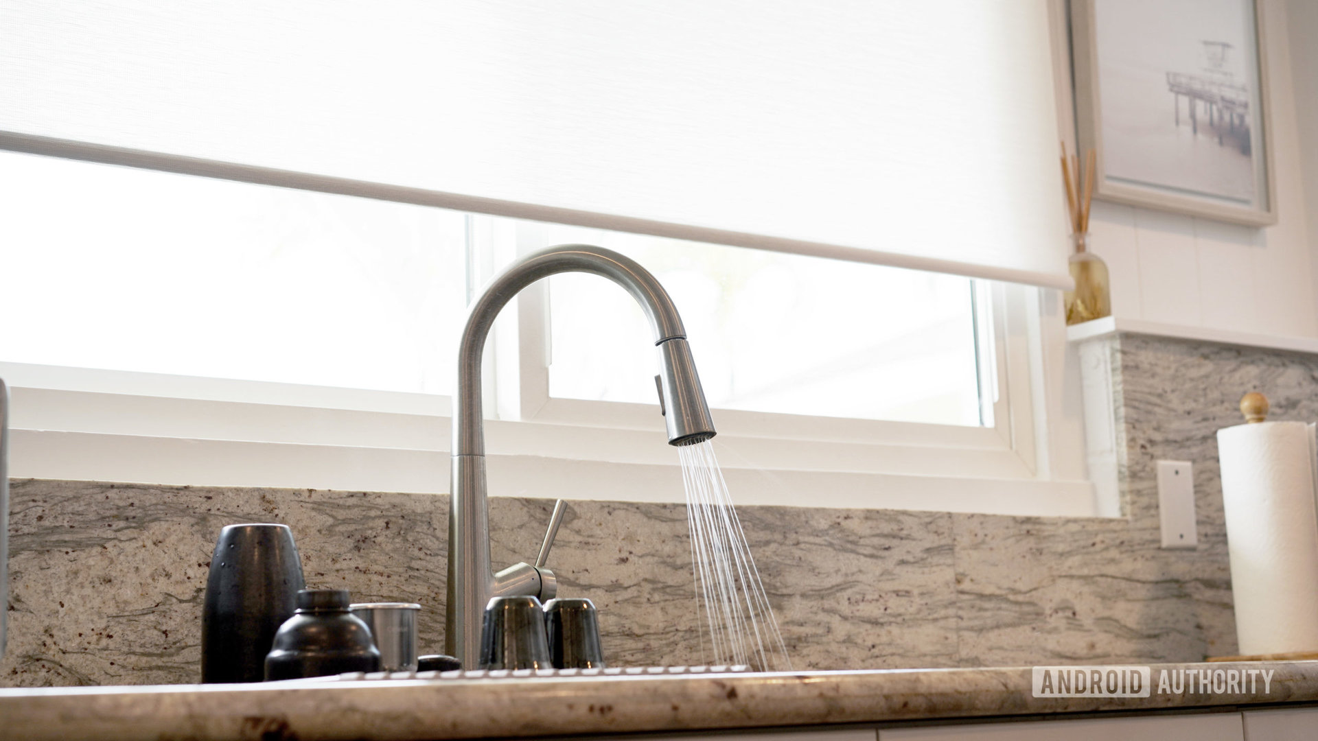 A smart blinds lifts to allow a user to wash dishes without splashing it.