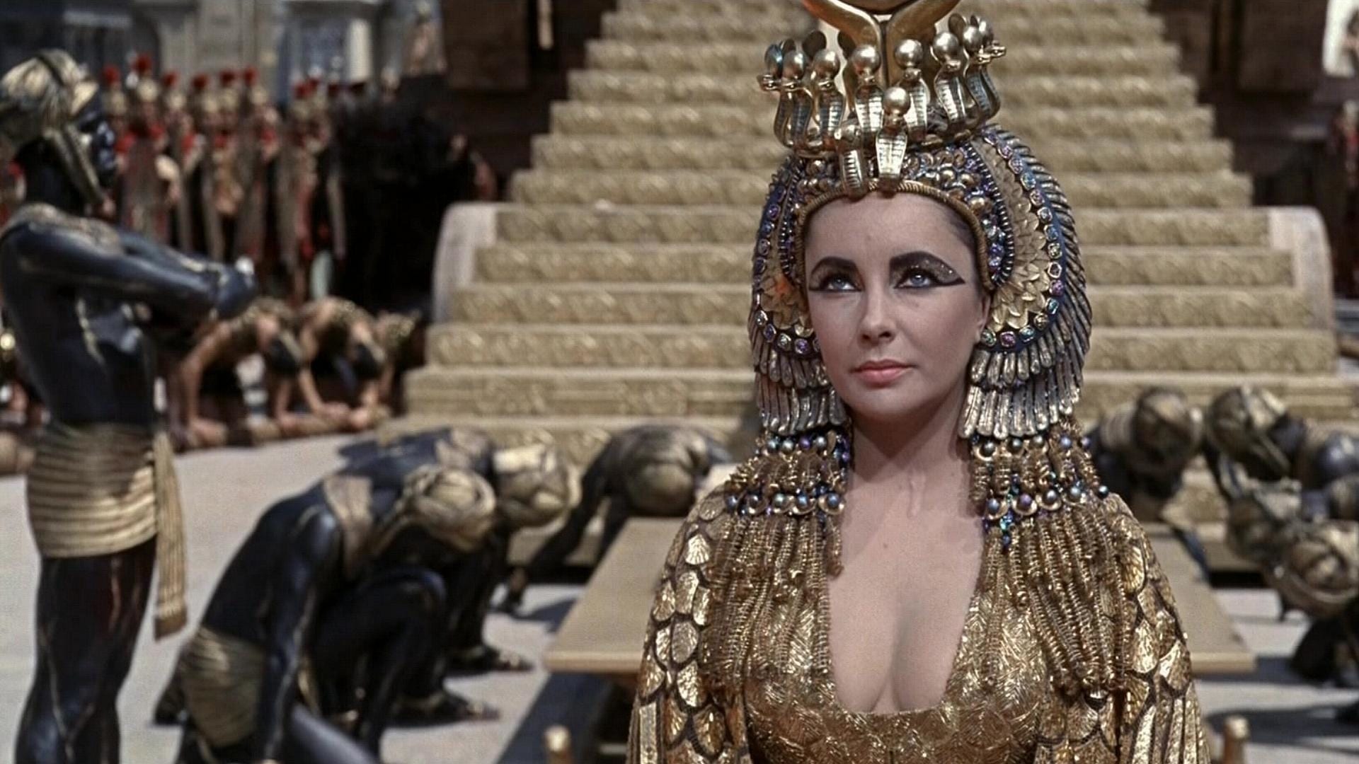 Slaves bow behind Elizabeth Taylor dressed as Cleopatra