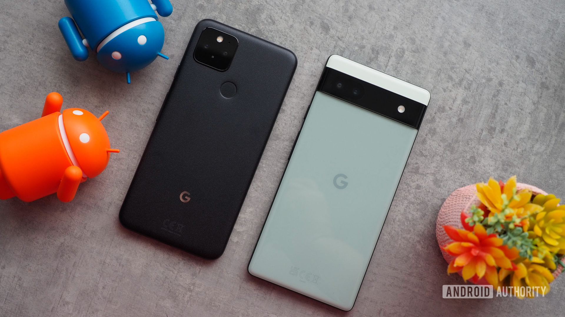 Google Pixel 5 next to Google Pixel 6a, seen from the back, tilted shot