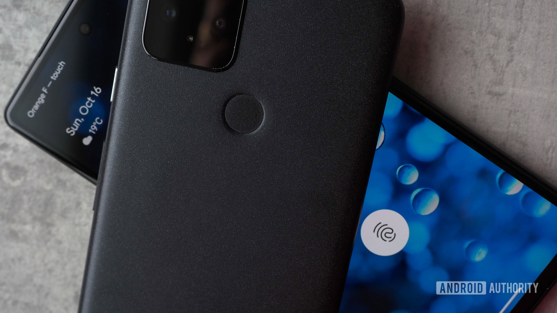 Google Pixel 5 on top of Google Pixel 6a, focus on the physical fingerprint reader versus in-display fingerprint reader