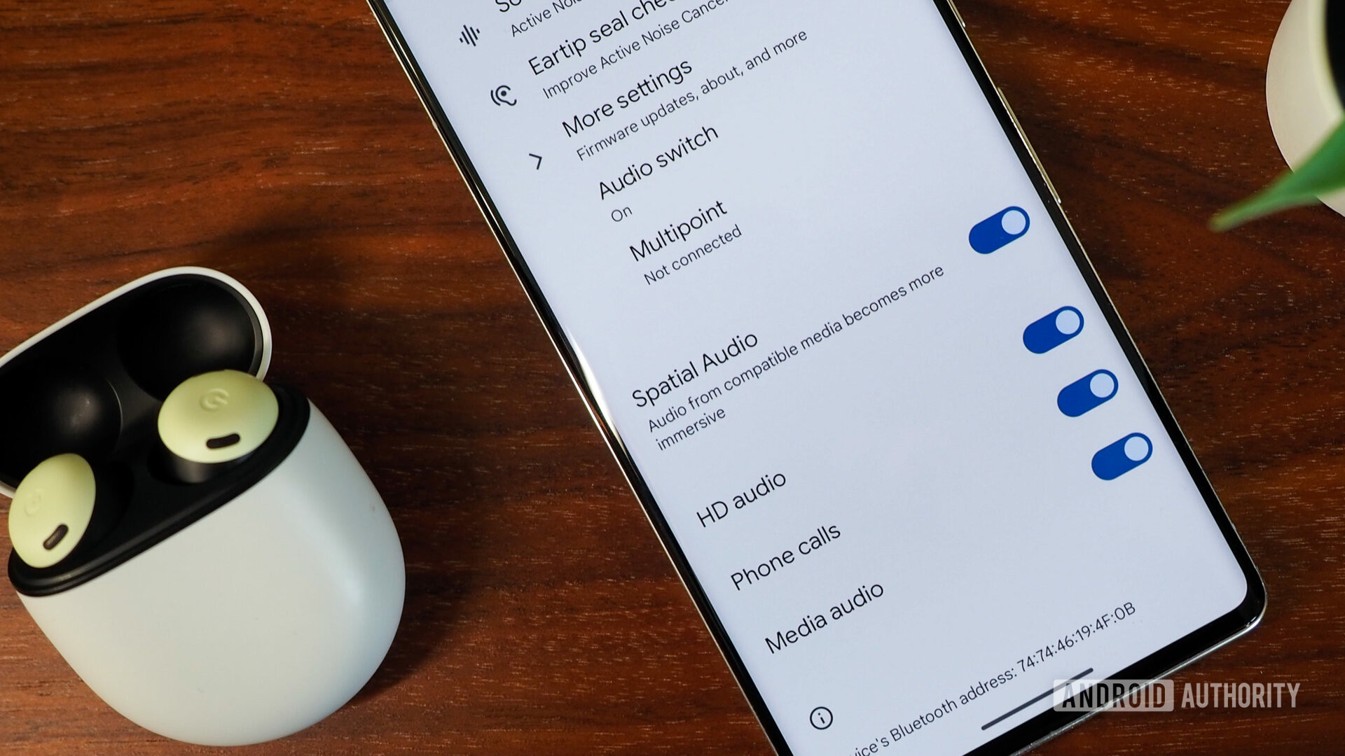 Google Pixel 7 Pro connected to Pixel Buds Pro and showing settings including spatial audio, close-up