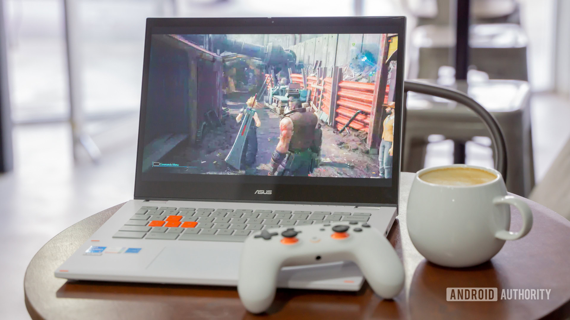 ASUS Chromebook Vibe CX34 Flip next to controller and coffee at a coffee shop