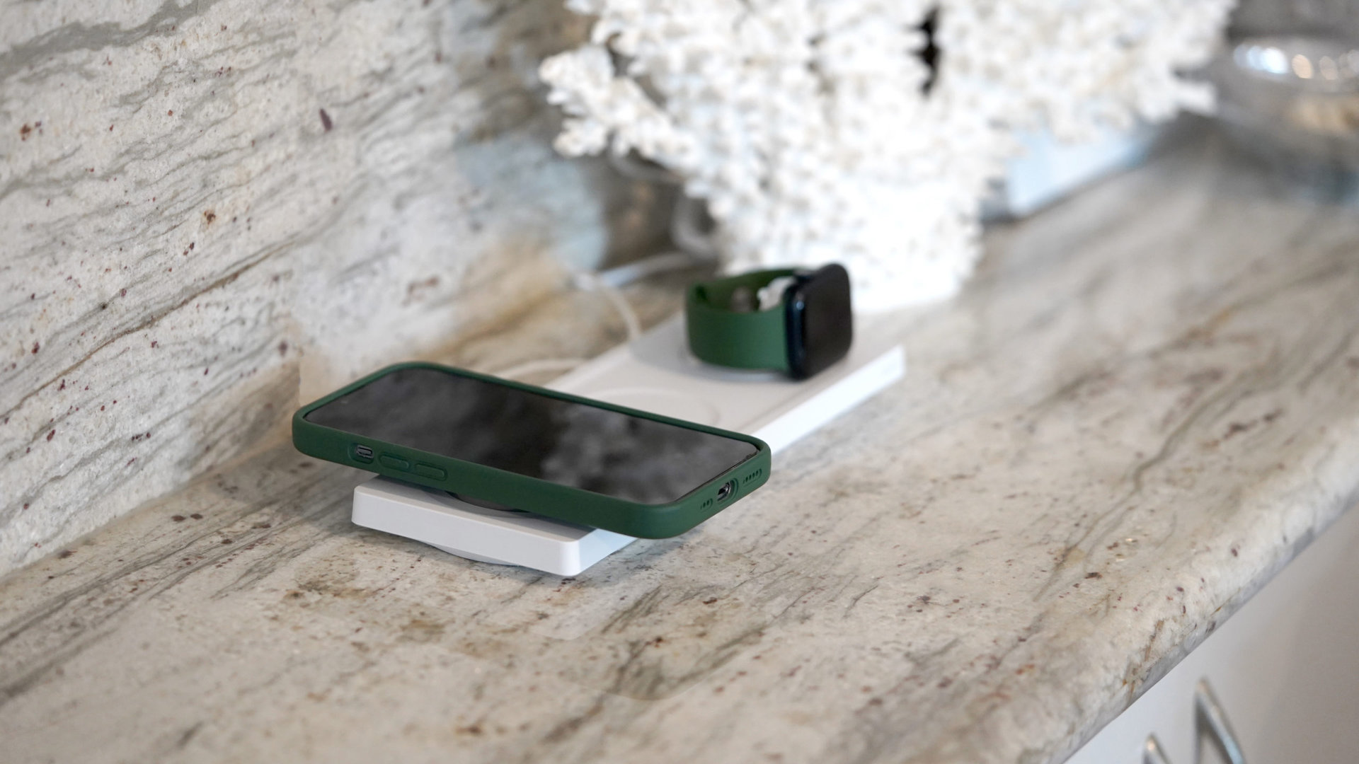 A Belkin BoostCharge Pro 3 in 1 Wireless Charger charges an iPhone and an Apple Watch.