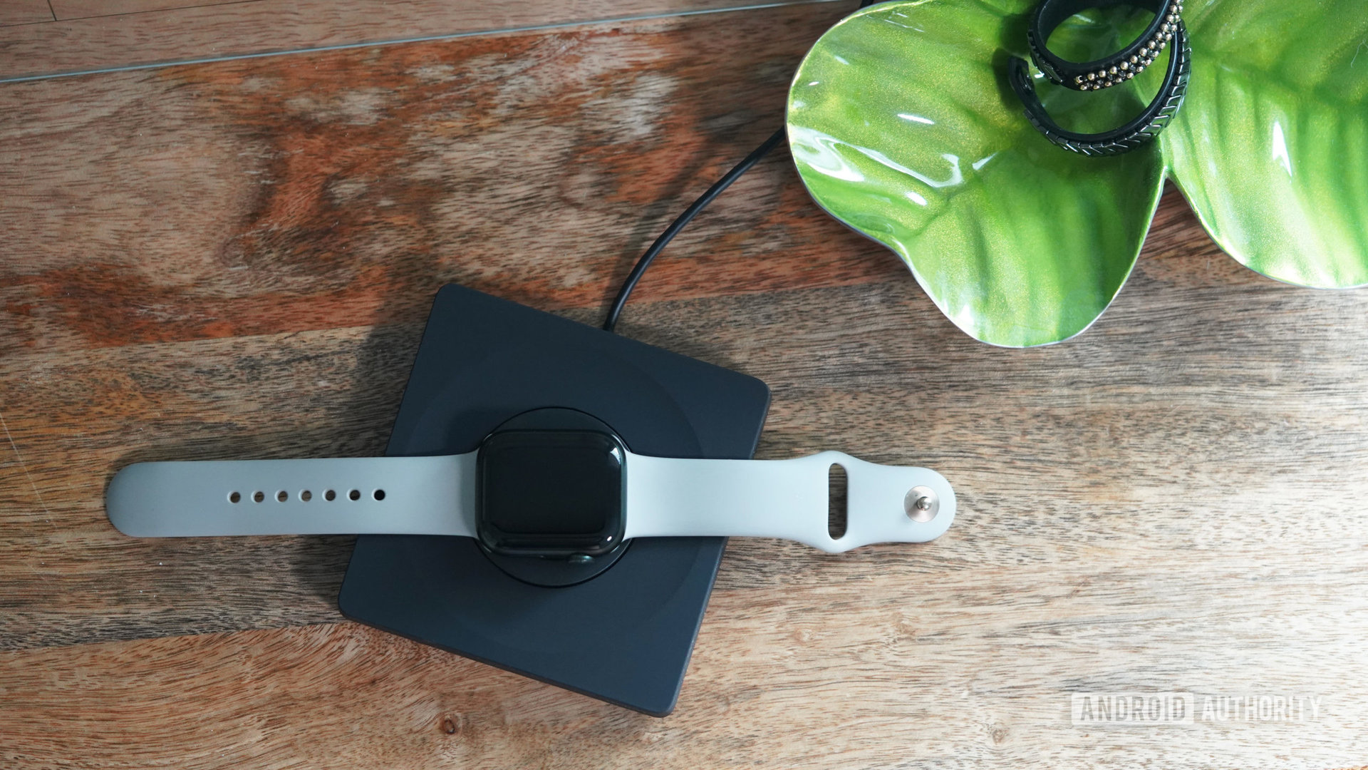 An Apple Watch Series 8 charges on a Belkin BoostCharge Pro Portable Fast Charger.