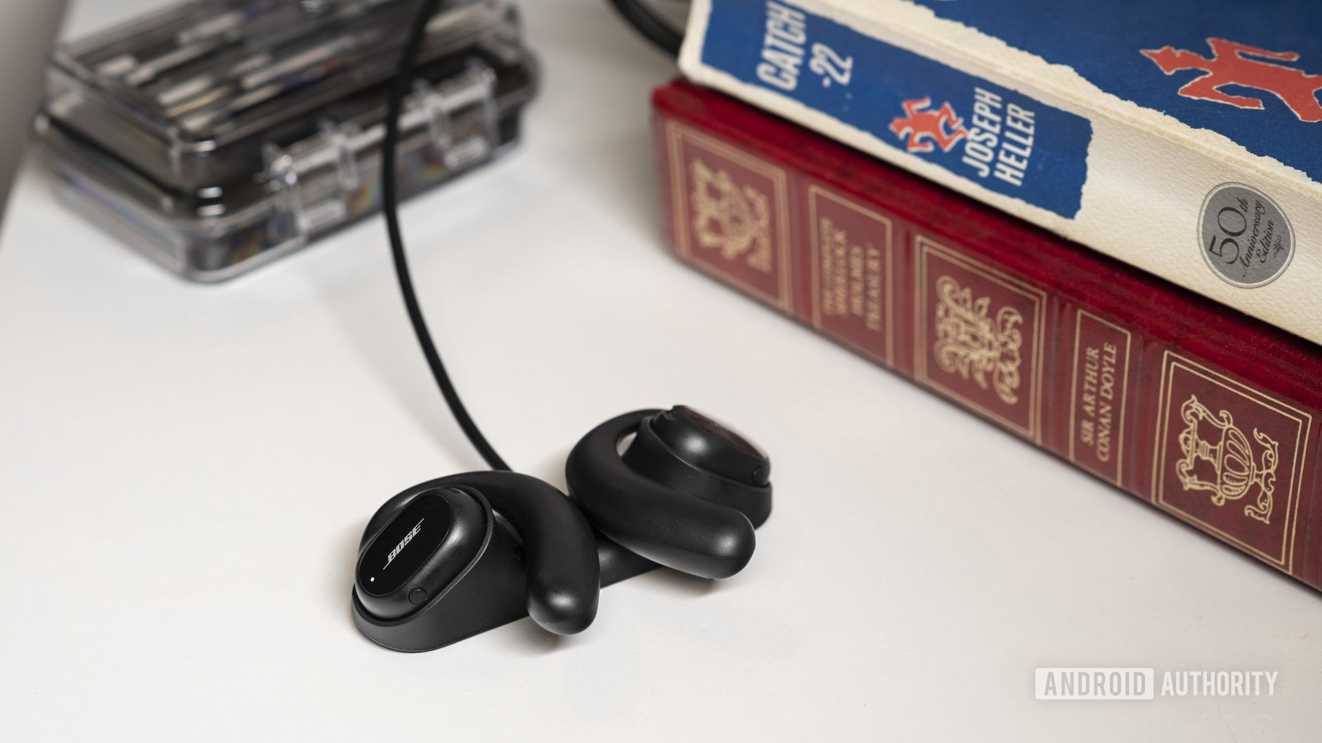 The Bose Sport Open Earbuds lay in the charging dock.