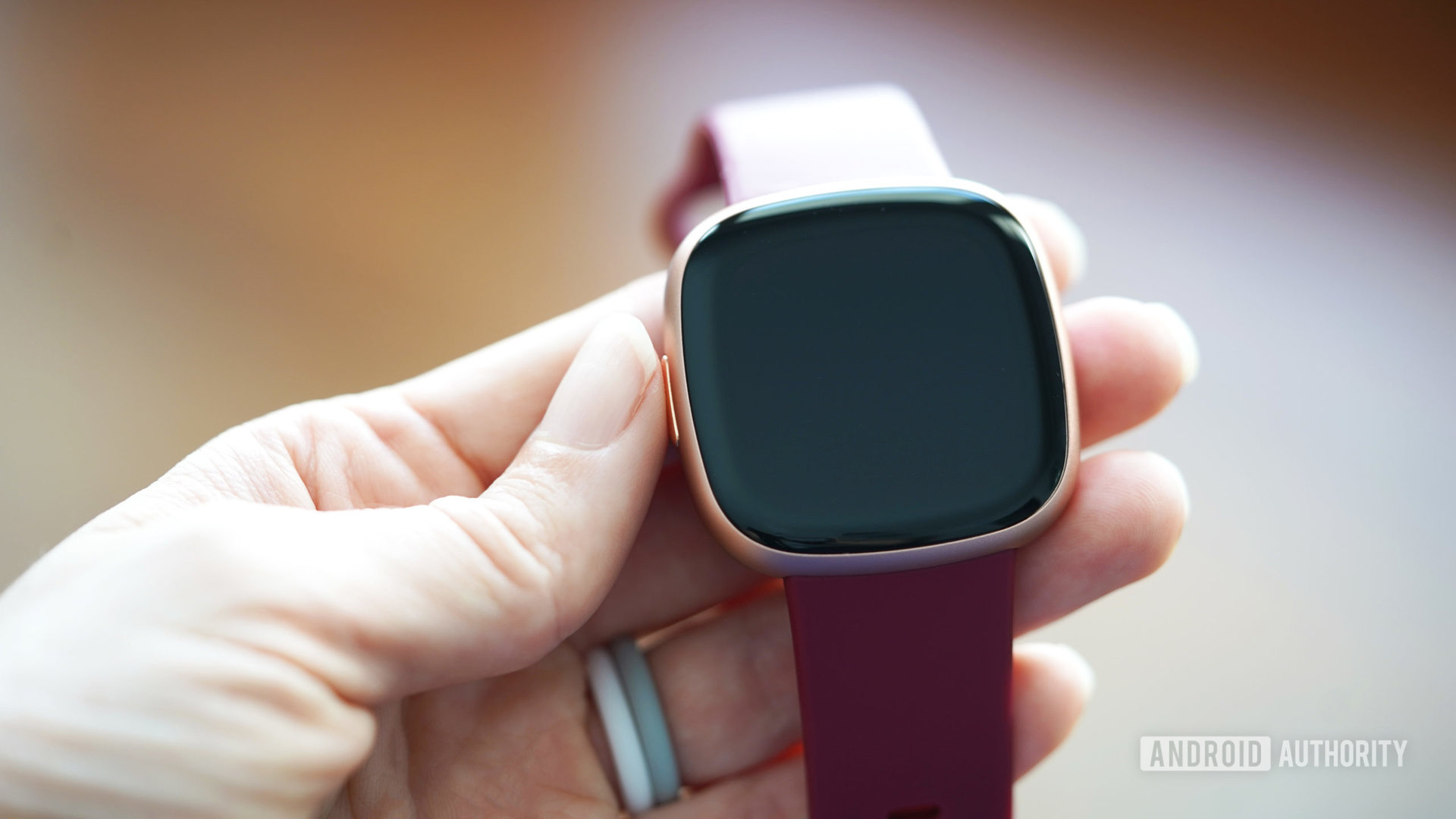 A user powers on their Fitbit Versa 4.