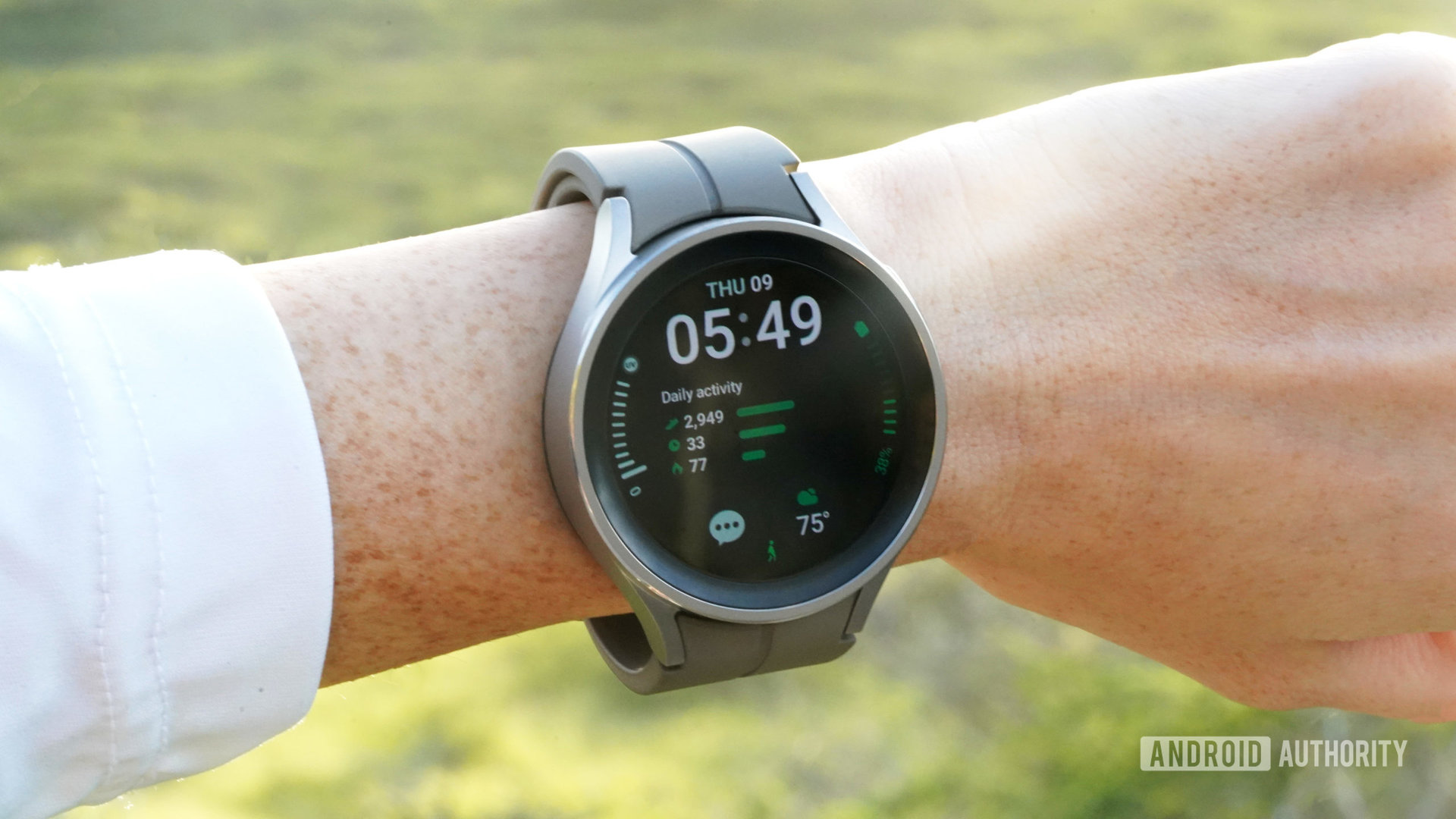 A Galaxy Watch 5 Pro on a user's wrist displays a detail-loaded watch face.