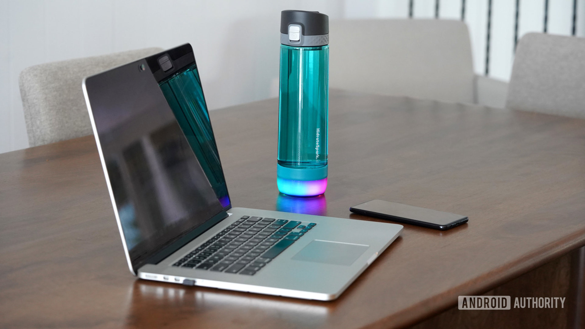 A HidrateSpark glows next to a user's work station.