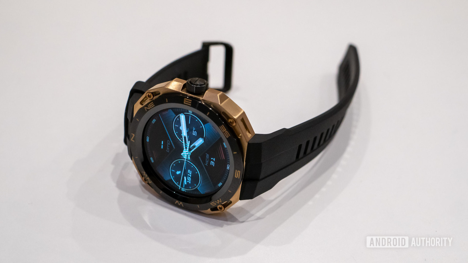 Huawei Watch GT Cyber smartwatch laying on a table showing watch face