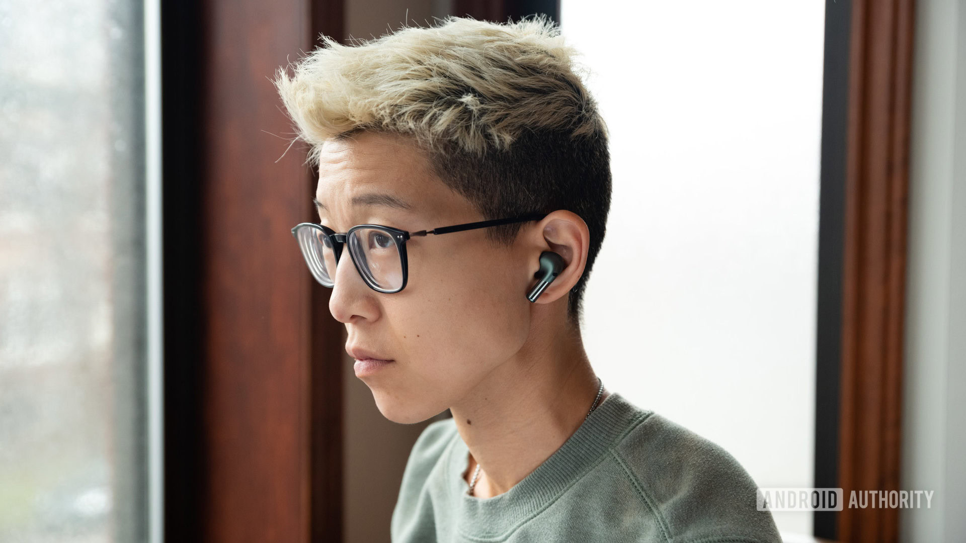 A person wears the OnePlus Buds Pro 2 noise cancelling wireless earbuds.