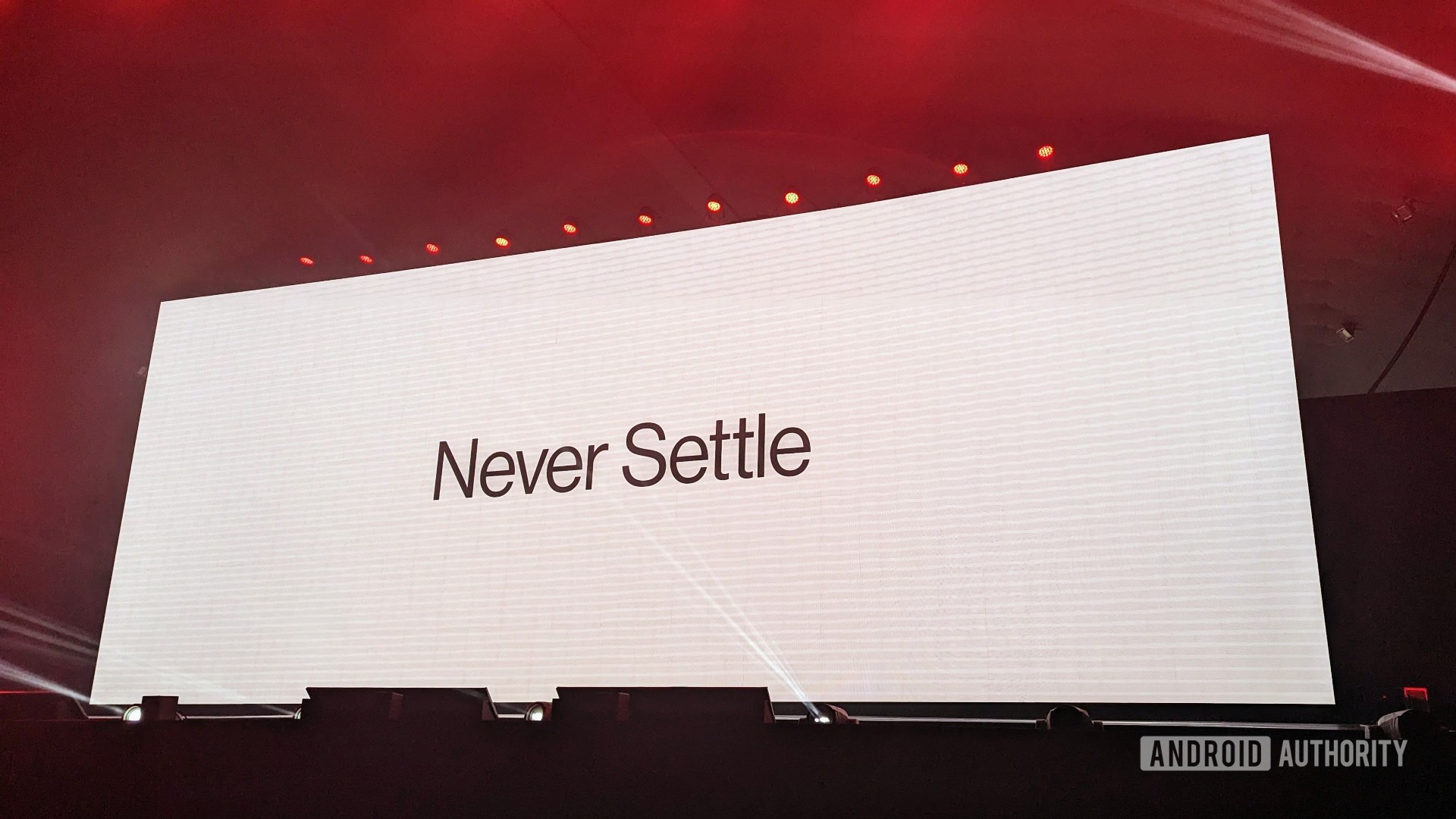 OnePlus NeverSettle Logo On Stage At OnePlus 11 event