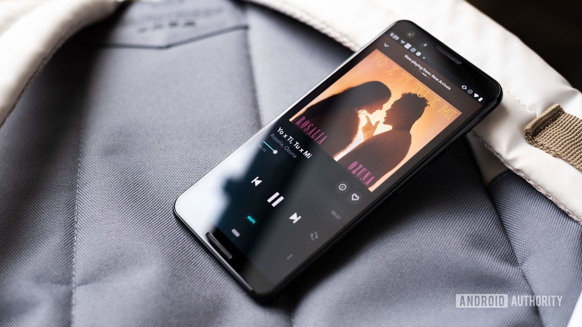 A Google Pixel phone displays the Tidal music player.