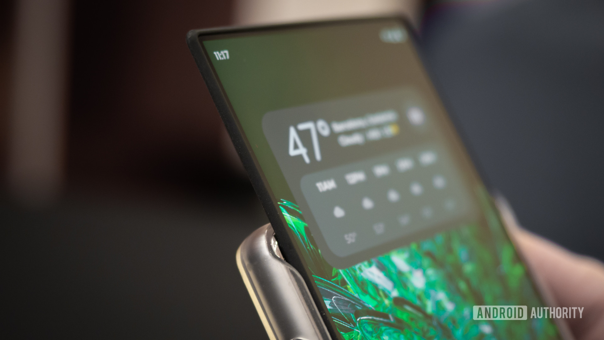 The display of the Motorola Rizr phone is rollable at the top