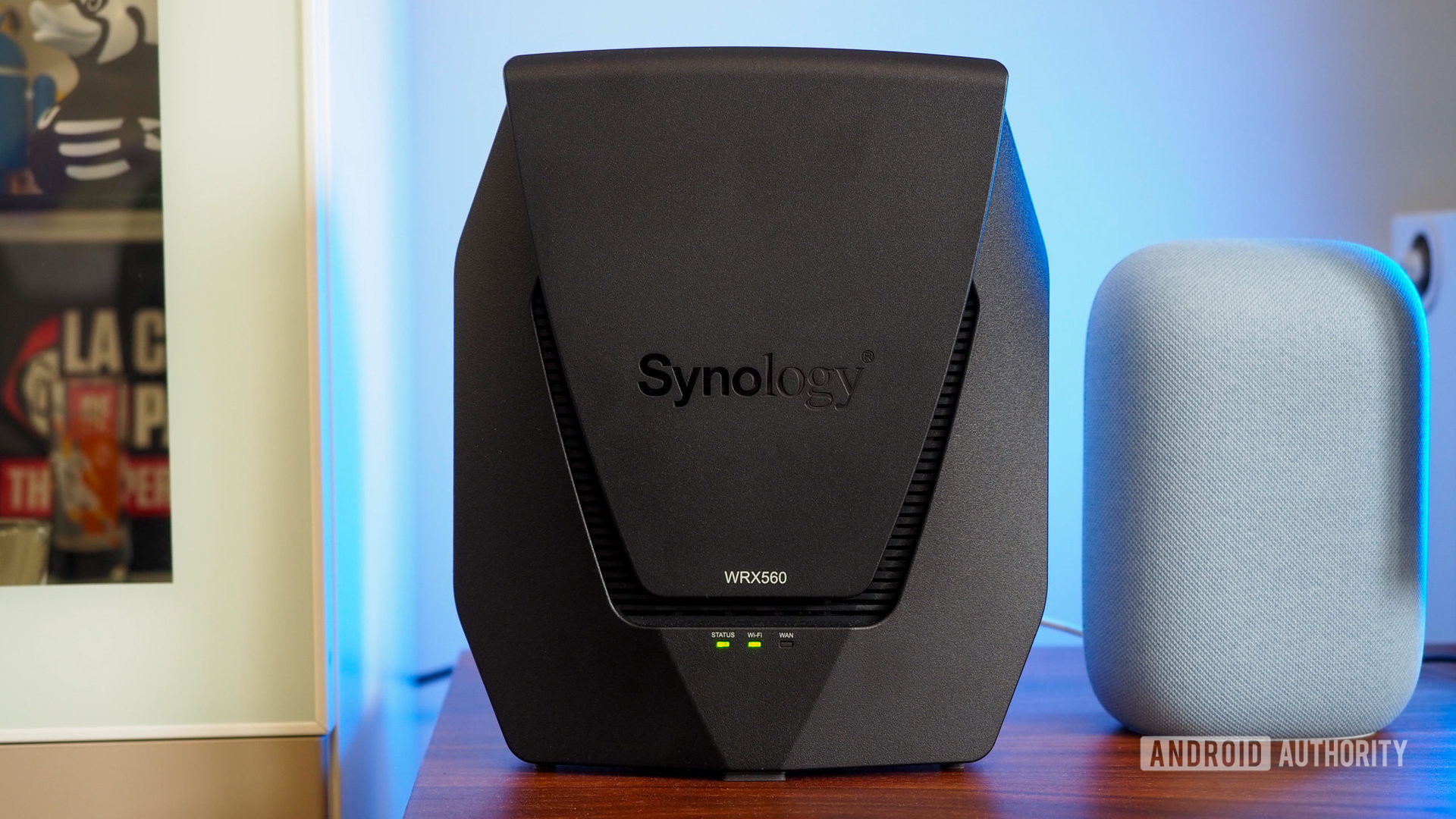 Synology WRX560 router next to a Google Nest Audio with a blue light in the background