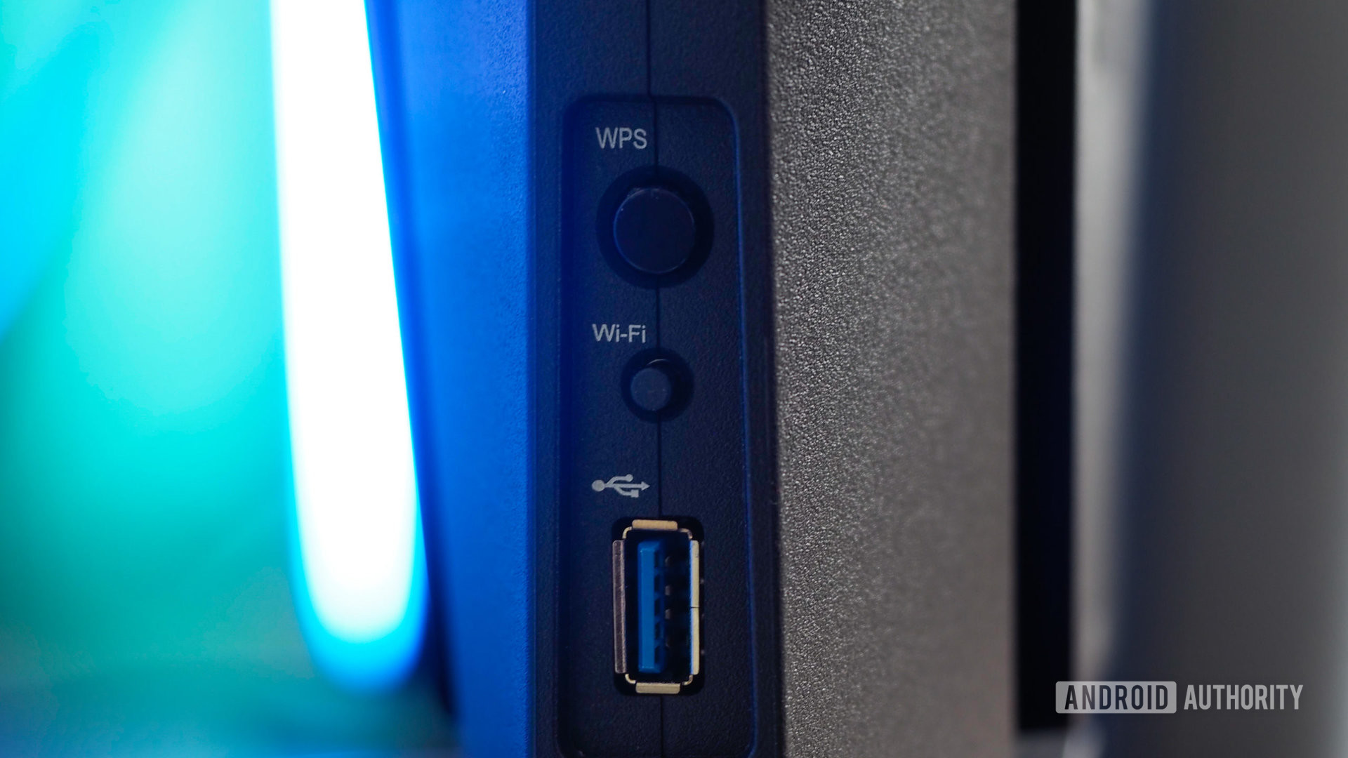 Synology WRX560 router seen from the side, focus on the WPS and Wi-Fi buttons and USB port