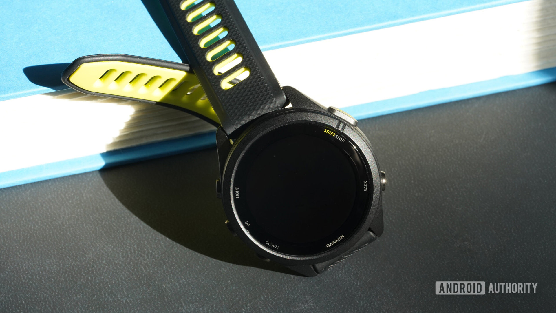 A Garmin Forerunner 265S rests with its screen dimmed.