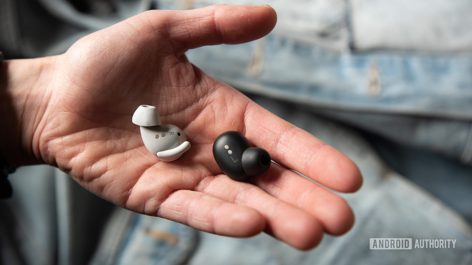 A hand holds the Google Pixel Buds Pro and Google Pixel Buds A Series to compare the earbuds' sizes.