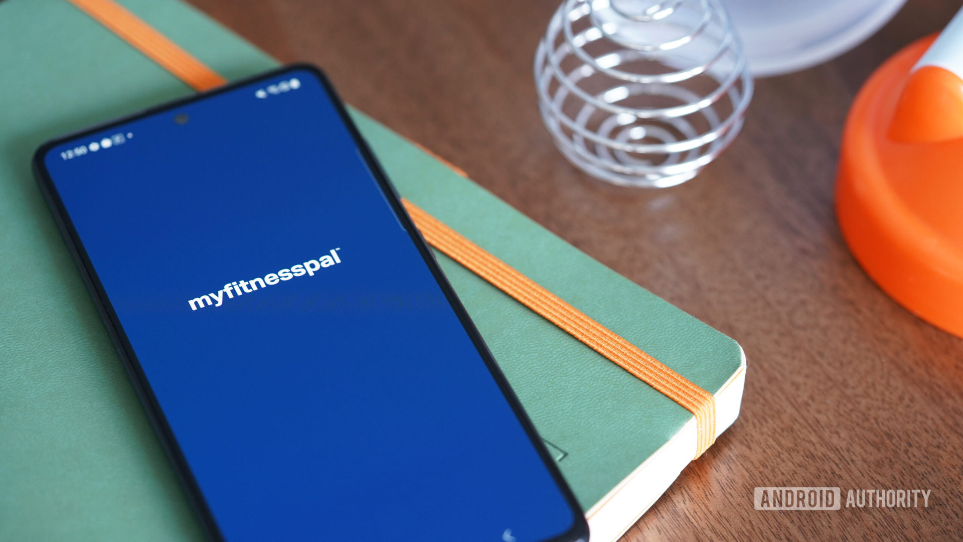 A Samsung Galaxy A51 displays the MyFitnessPal app's opening screen.