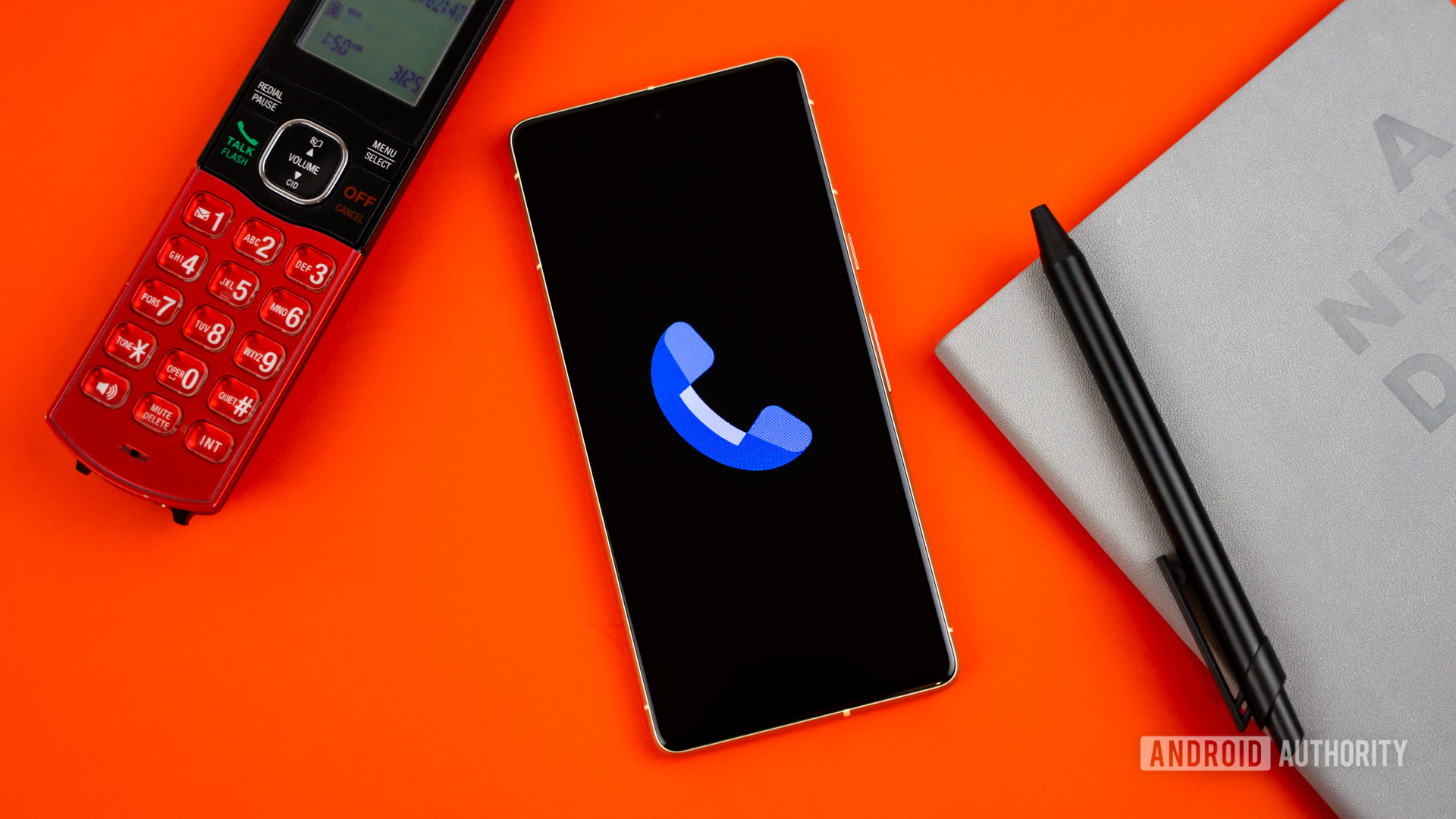 Stock photo of Phone by Google app on phone next to home phone agenda and pen 1