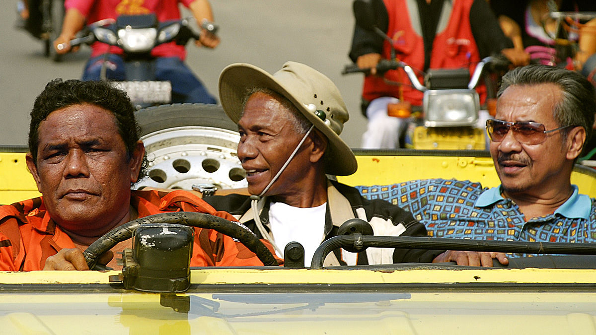 Three men in a convertible car in The Act of Killing - best hulu movies