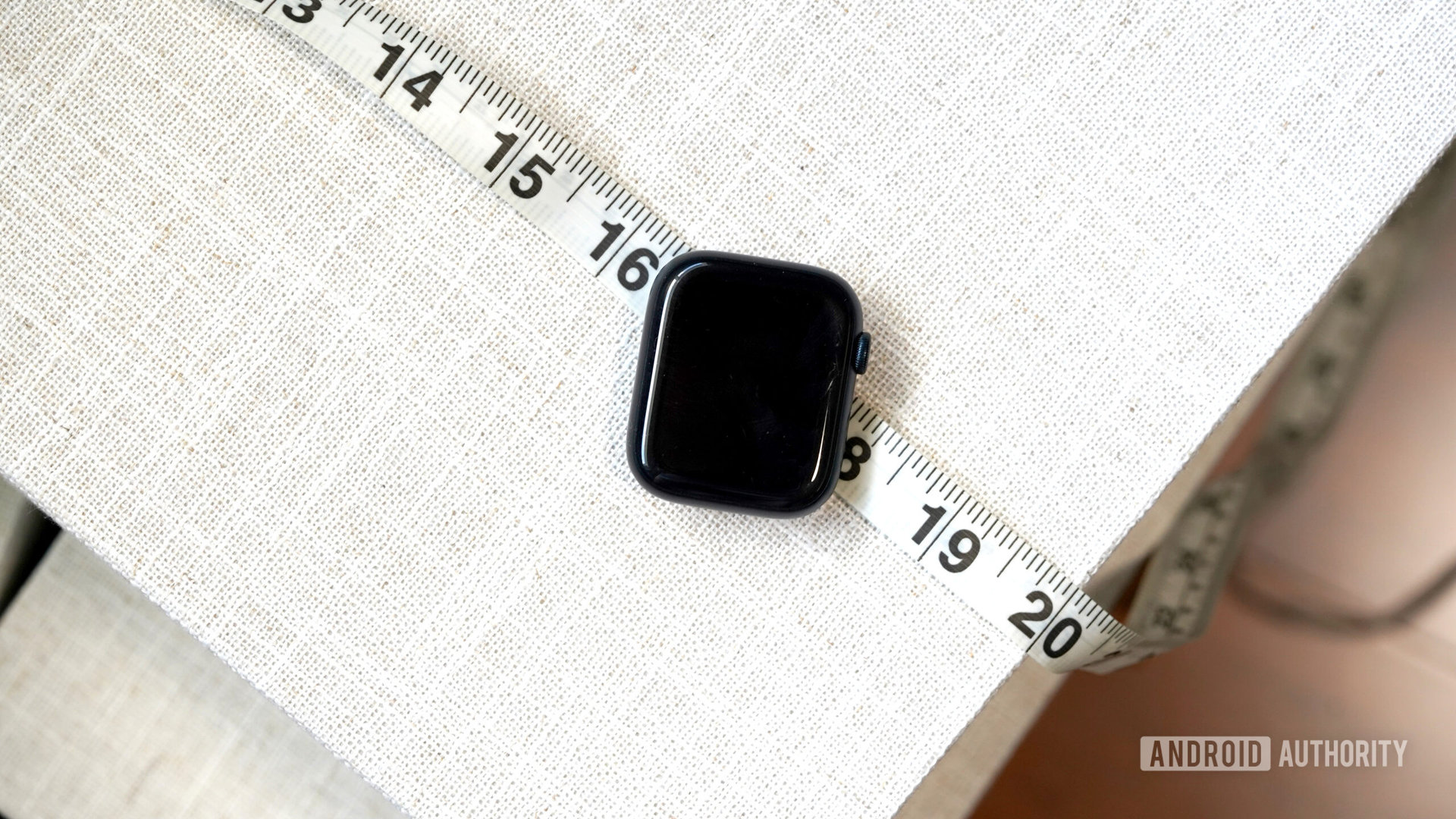 An Apple Series 8 Case rests on a measuring tape.