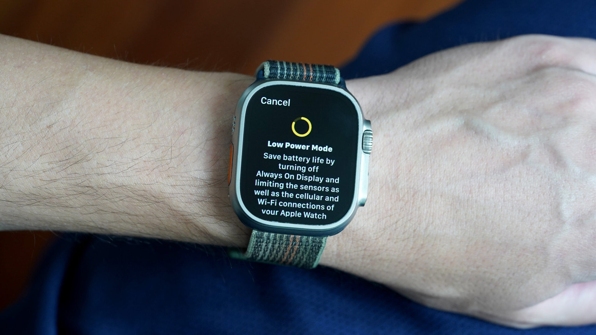 An Apple Watch Ultra on a user's wrist displays the Low Power Mode info screen.
