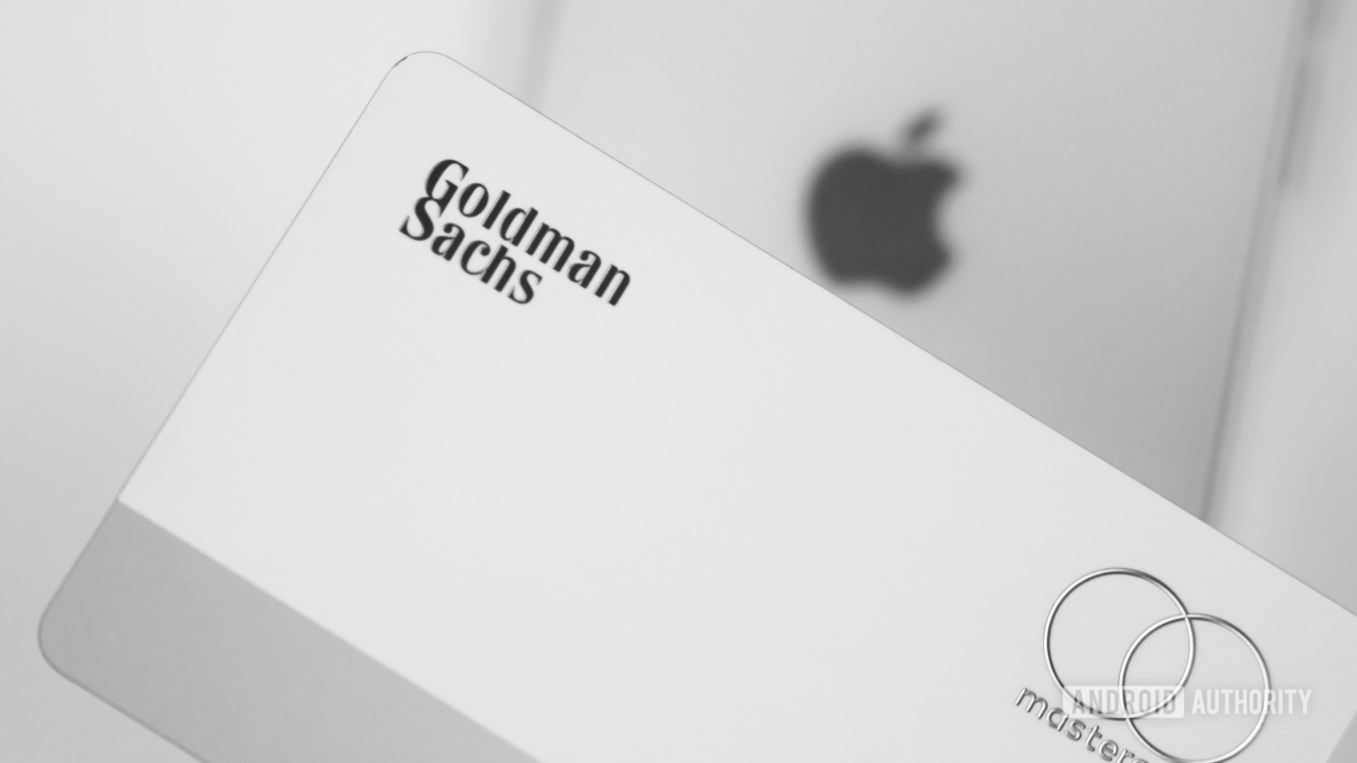 Goldman Sachs next to Apple smartphone showing logo Stock Photo